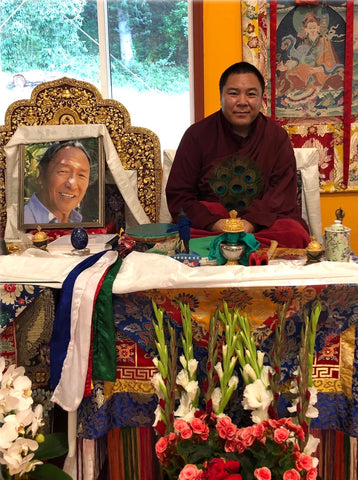 Chakung Jigme Wangdrak Rinpoche next to Lama Tharchin Rinpoche's throne, Pema Osel Ling. Photo by Sonam Basiga Famarin