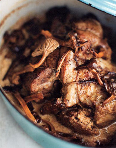 Cast Iron Pot of Staffan's Milk Braised Pork Shoulder with Yellowfoot Mushrooms made with Wine Forest Wild Foods premium dried wild yellow foot mushrooms.