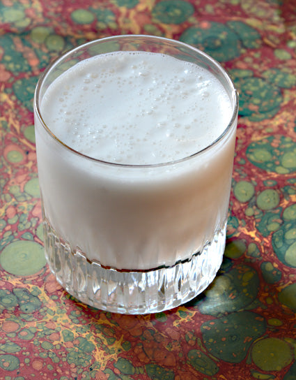 Short glass of frothy Candy Cap Milk Punch made with Wine Forest Wild Foods Wild Candy Cap Mushroom Tincture