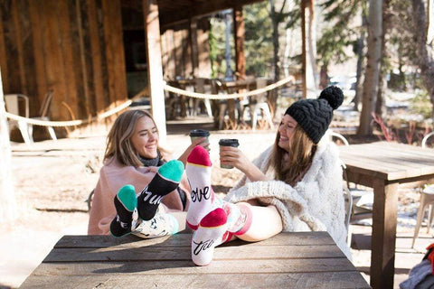 girls sitting outside with hot chocolate