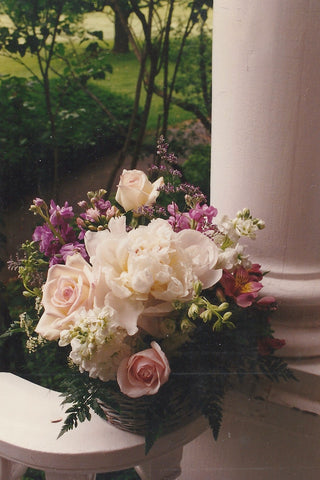 Herbaceous peony, roses, larkspur form the basis of this fragrant basket.