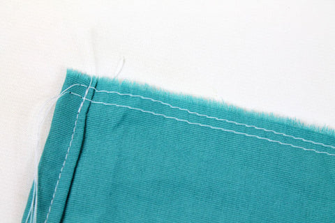 double basted raw edge of crib skirt