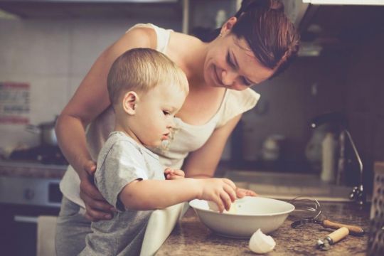 smiling mom cooking with child