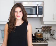 Lauren singer in her kitchen, reviewing our magnetic spice jars for her website, Trash is for Tossers.