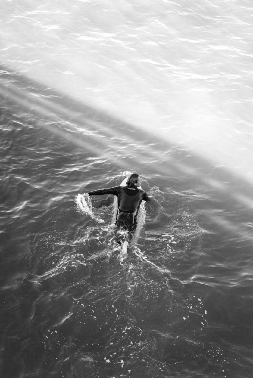 Surfer paddling in ocean 