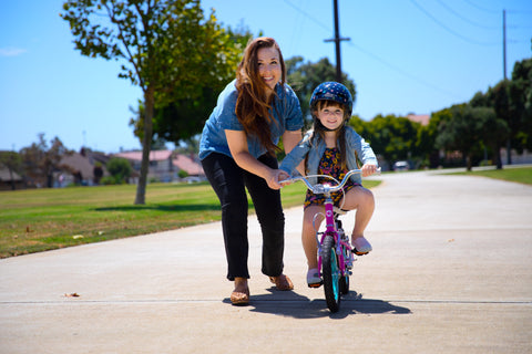 Teaching kid to ride holding their side