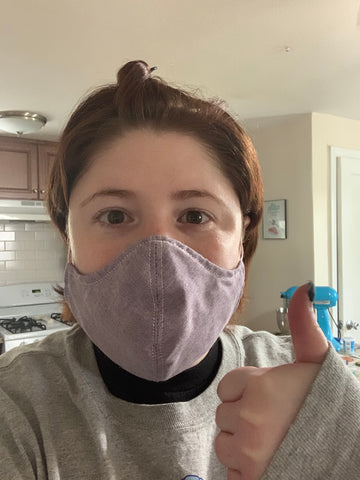 Woman Wearing A Mask Giving A Thumbs Up.