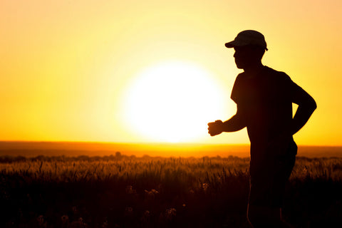 running at sunset with hat