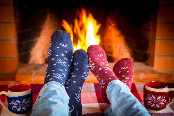 holidays-relax socks by fire couple