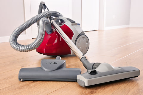 canister vacuum on hardwood floor