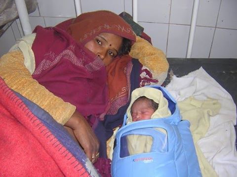 Shamko and her baby in an Embrace infant warmer