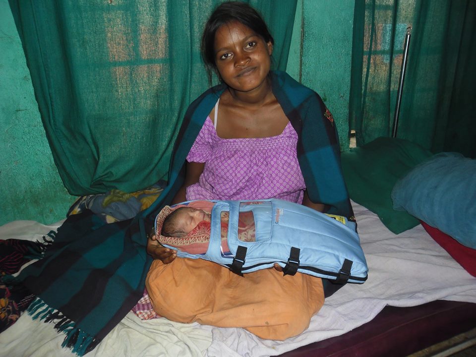 Belmati and her baby in an Embrace infant warmer