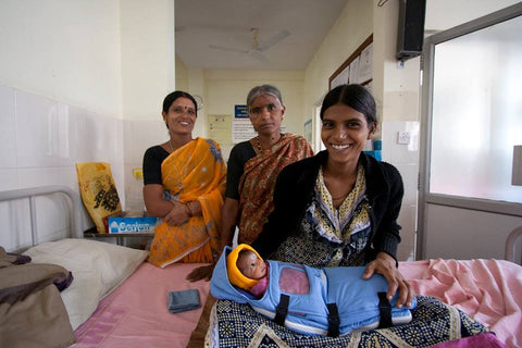 Women and baby in Embrace infant warmer