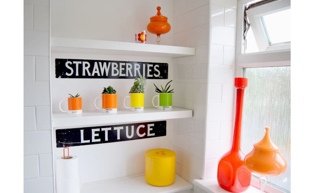 House Tour - Sophie's Bathroom with vintage signs and coloured glass vases.