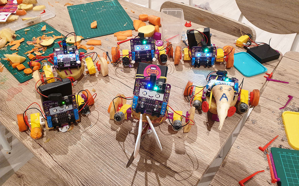 An image of six vegetable robots, made from potatoes, parsnips and carrots