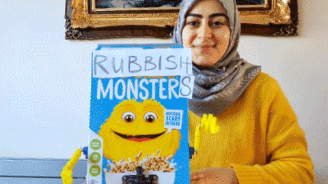 A GIF of a blue and yellow cereal box, that has "Rubbish Monsters" written over it.