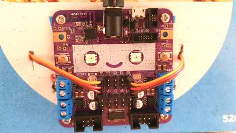 Image of a purple circuit board with two wires attached to it