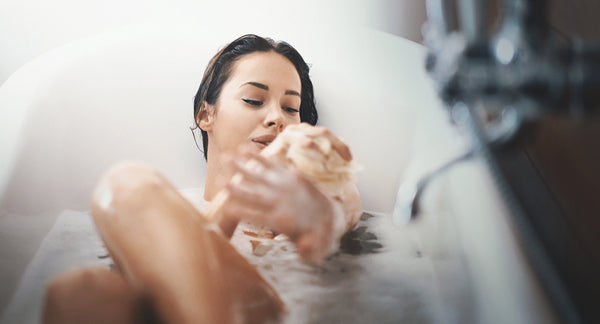 woman using soap in bath
