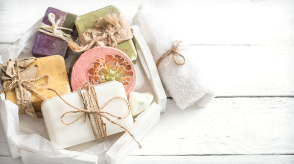 variety of bath soaps sitting on white table