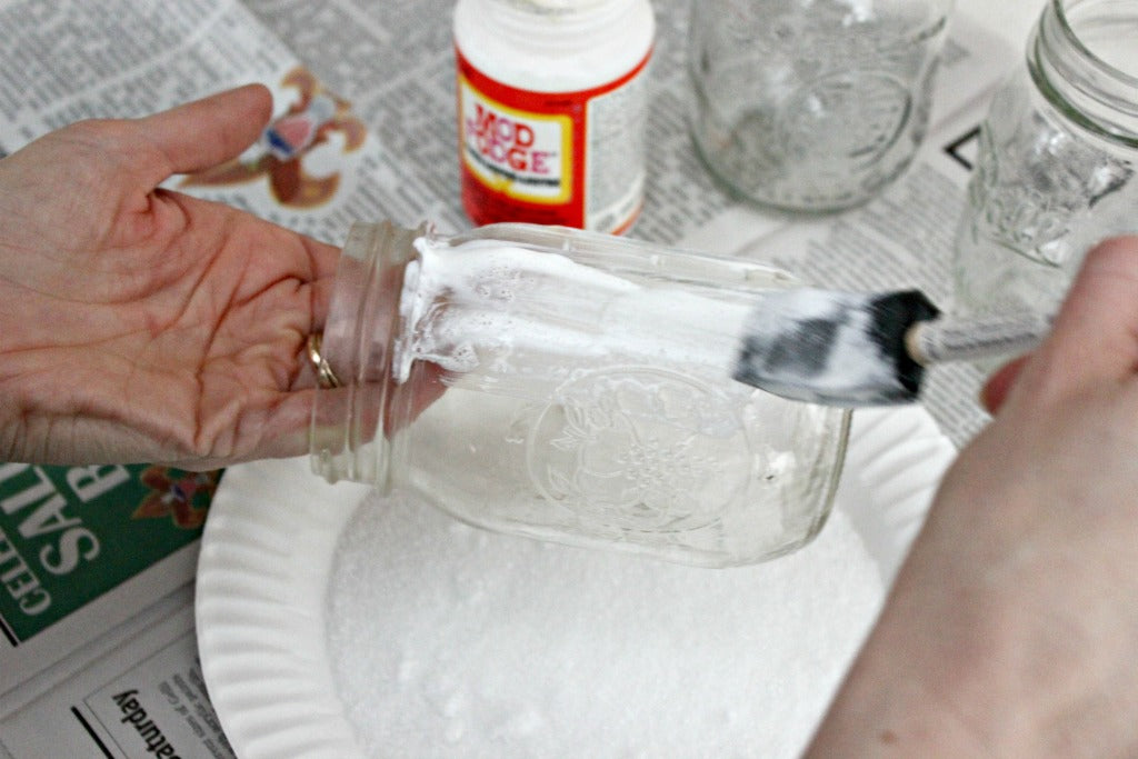 Apply Mod Podge to the Mason jars to create the Epsom salt luminaries