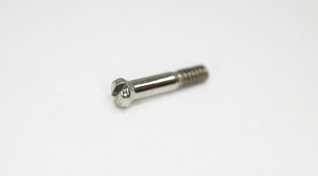 A glasses frame dowel screw lying on its side