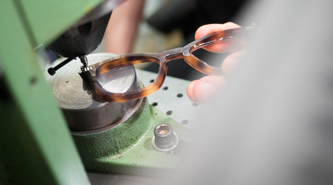 A tortoise glasses frame having its hinges attached with rivets