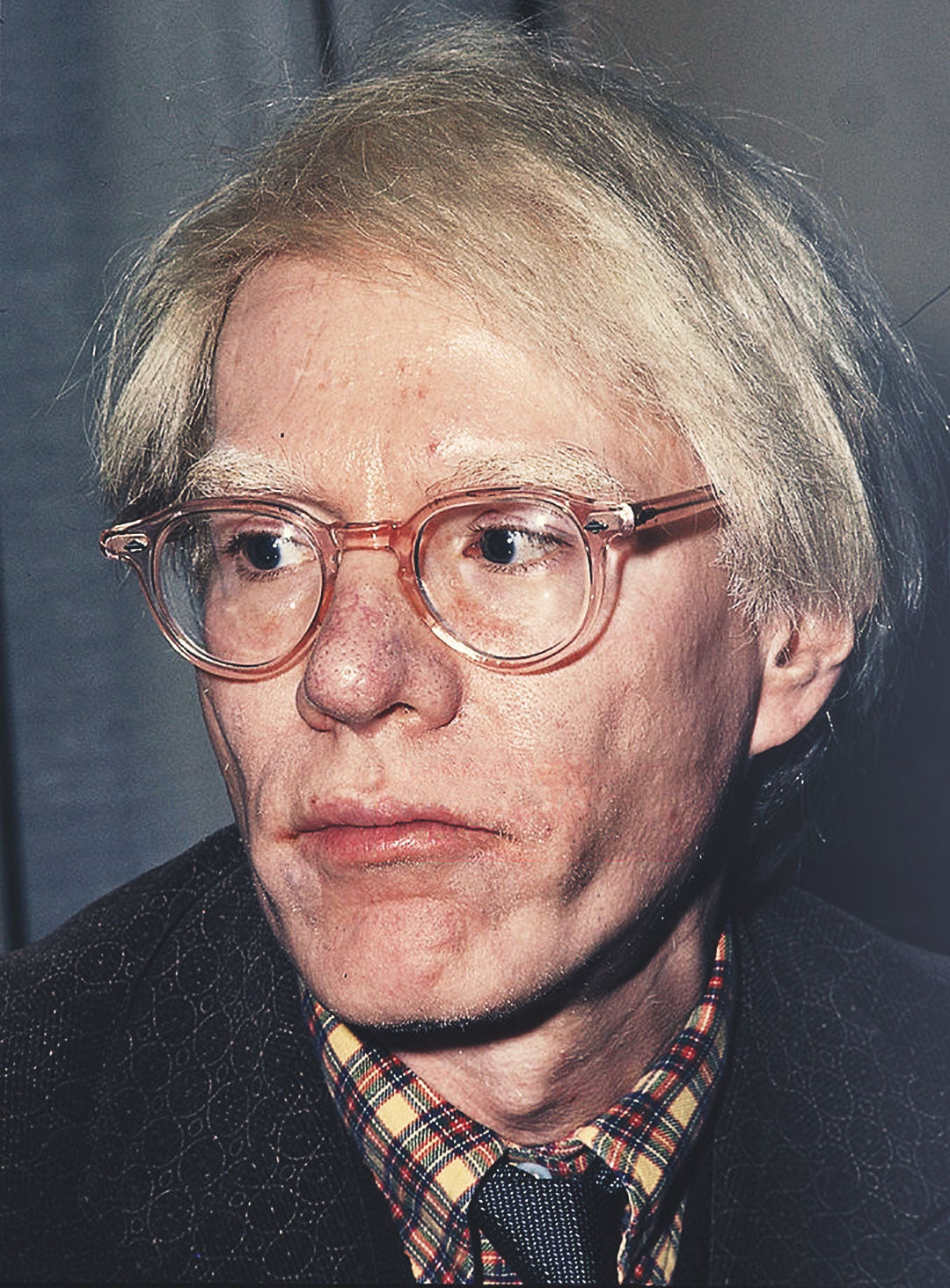 Andy Warhol wearing transparent pink glasses