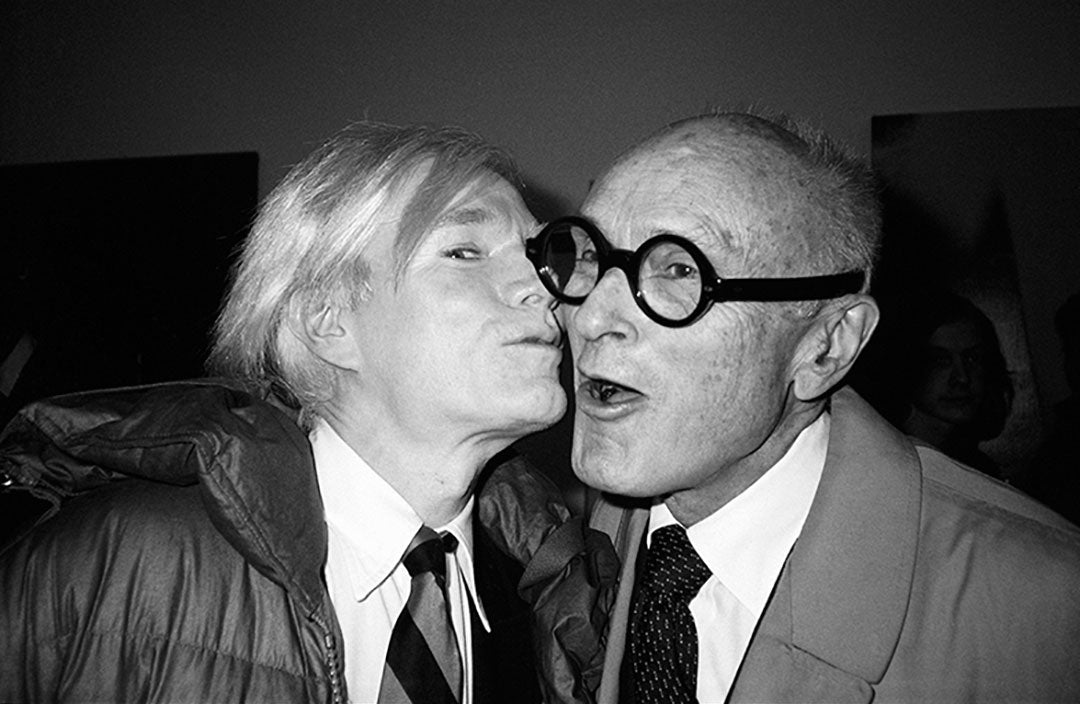 Artist Andy Warhol kissing architect Philip Johnson