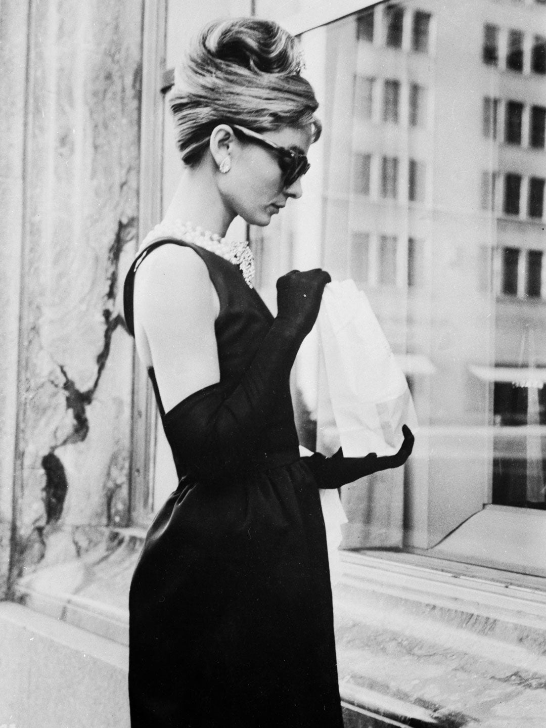 Audrey Hepburn outside Tiffany's New York wearing sunglasses and black dress