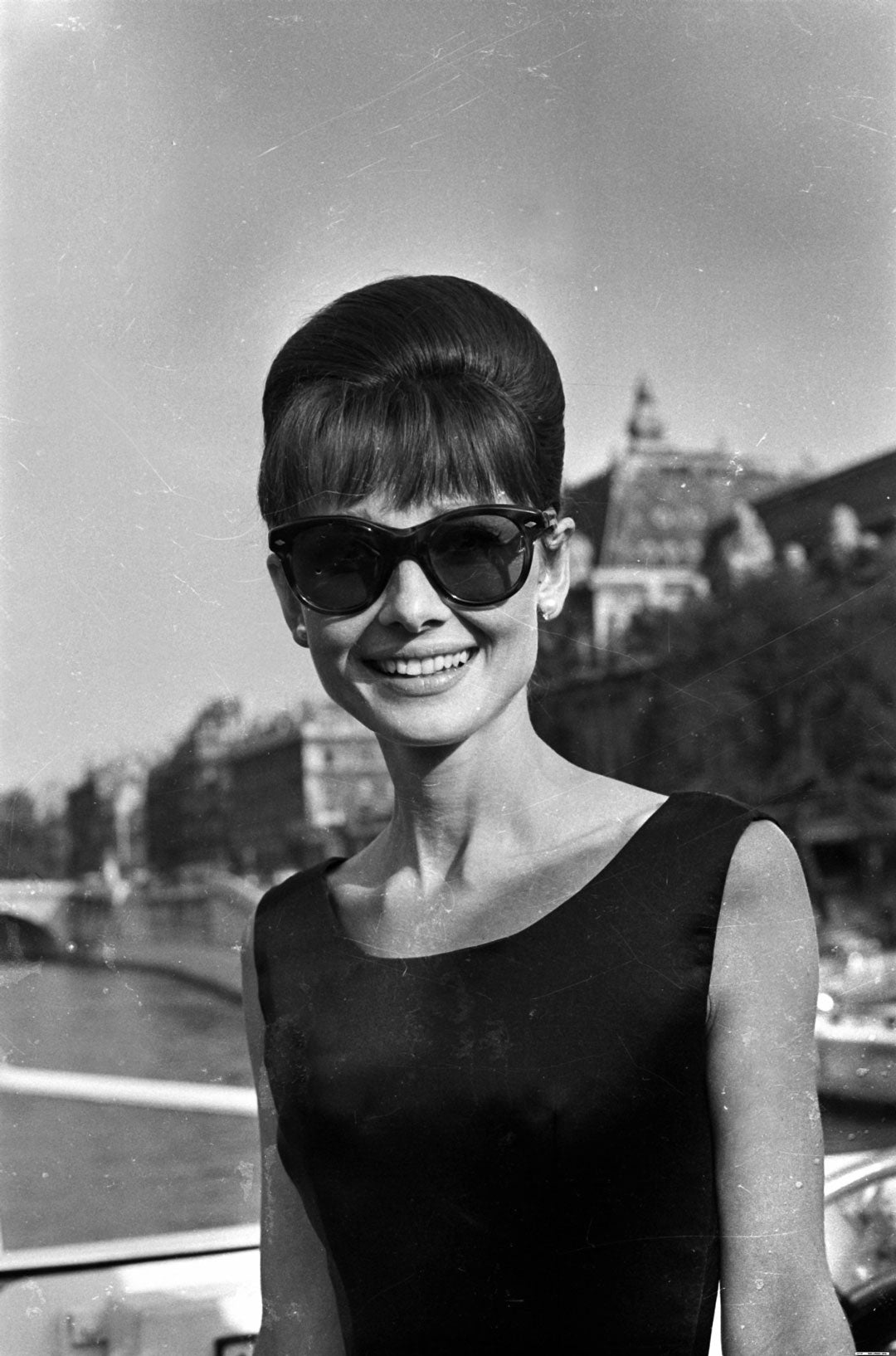 Audrey Hepburn wearing large frame sunglasses and black dress