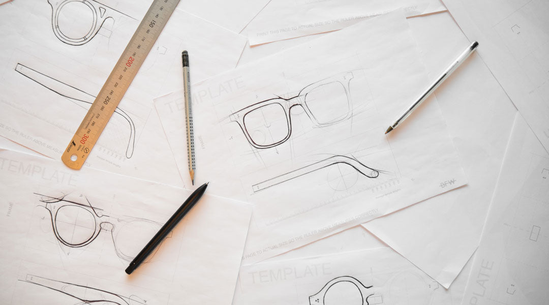 Biro pen drawings of sunglasses frames using a design template ruler and pencil