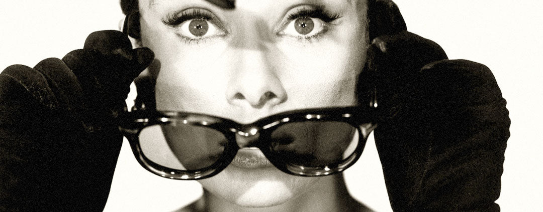 Close view of Audrey Hepburn taking off her sunglasses