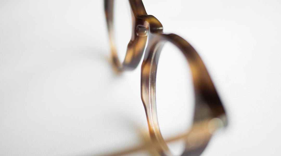 Focused view of a glasses frame with an acetate pad bridge