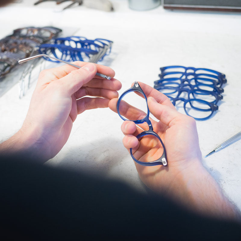 Glasses-frame-assembly-on-white-workbench