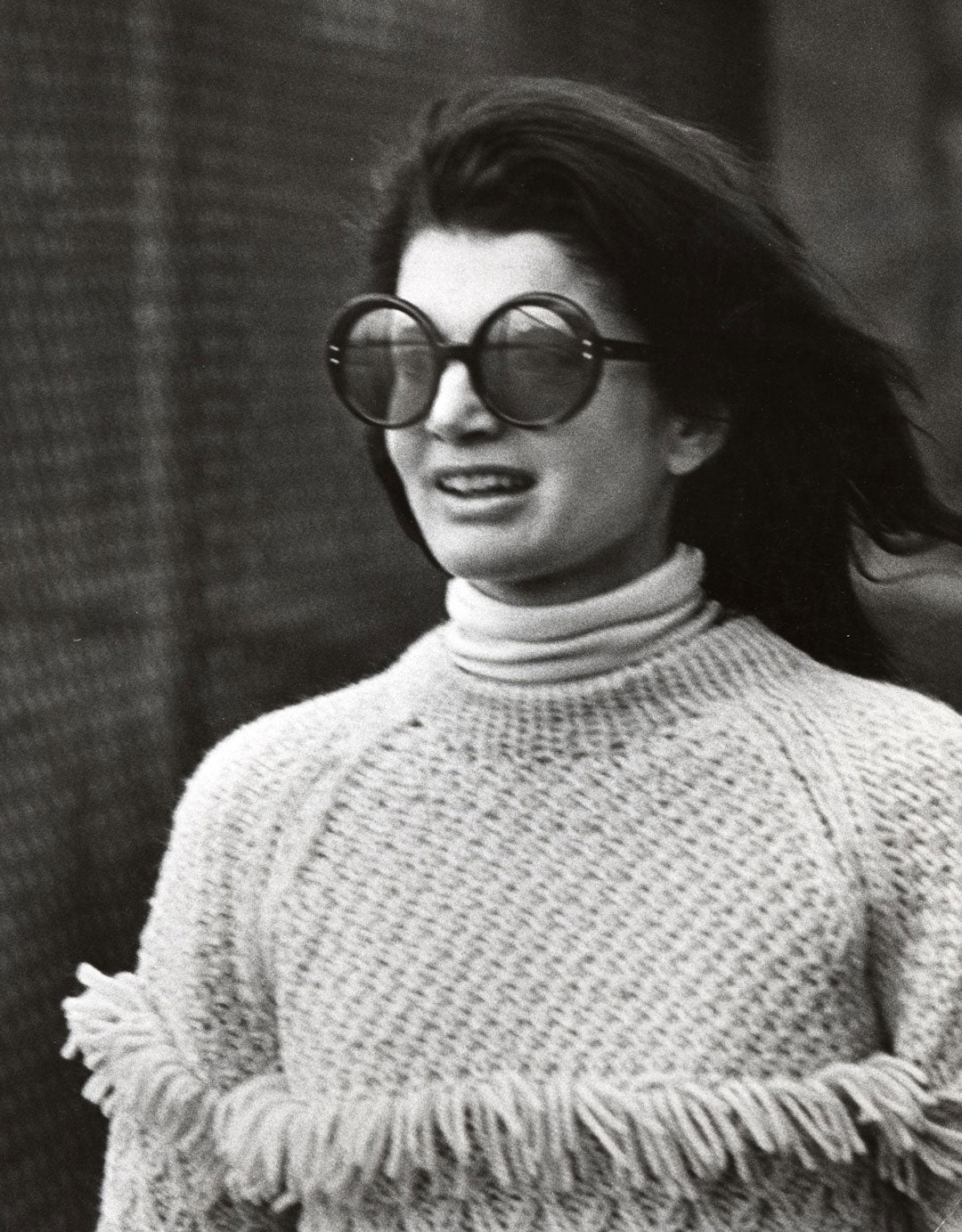 Jackie O wearing large round sunglasses