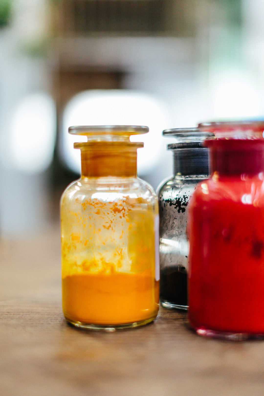 Yellow and red powdered dye inside two glass jars