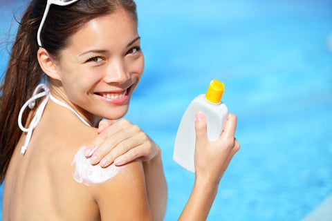 Woman wearing sunscreen to have radiant skin