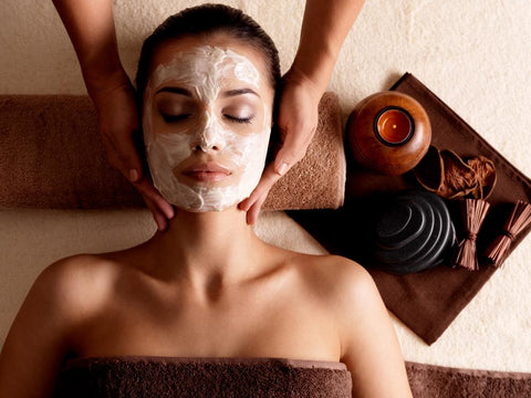 woman getting a turmeric face mask at a spa