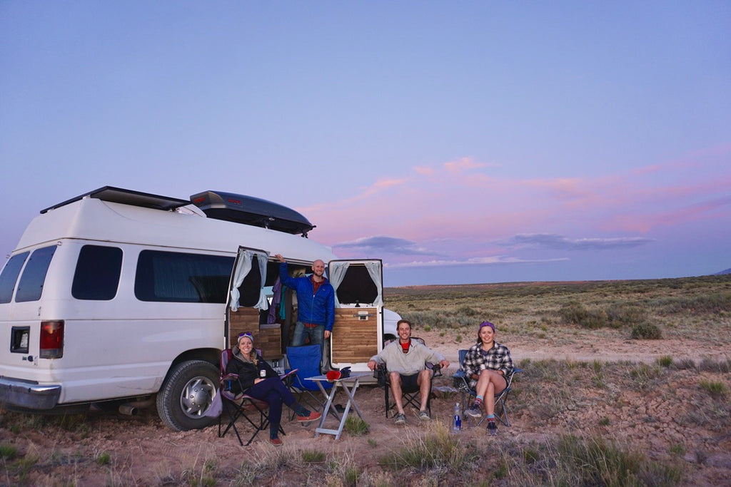 Jake and Emily with friends and their van outsdoors