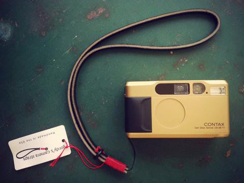Contax camera neck strap. Single attach point string. Dark brown leather, red wrap. 