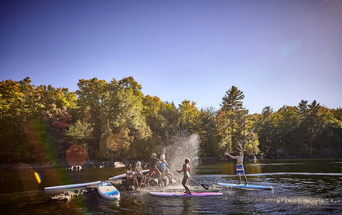 stand up paddle boarders on a lake