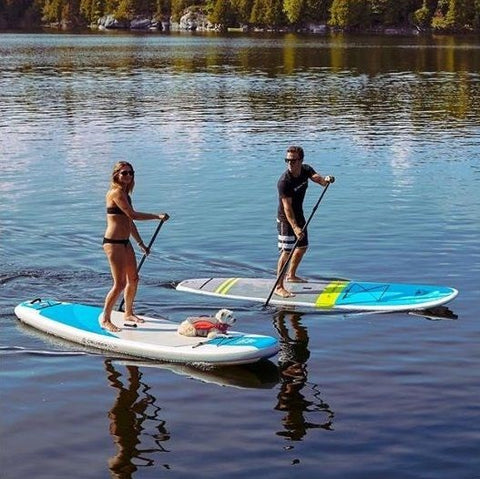 stand up paddle boarding on a lake using non-inflatable paddle boards