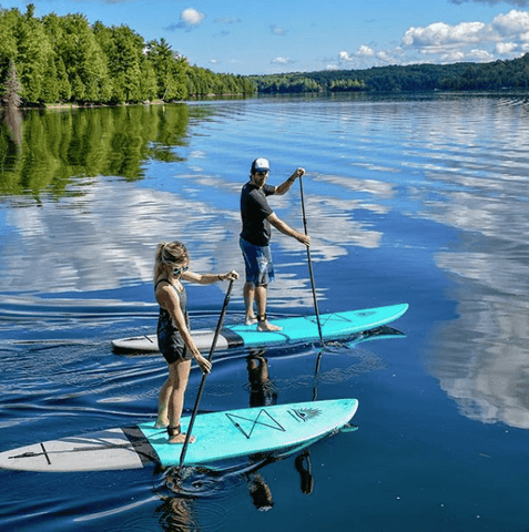 paddle boarders on a calm lake