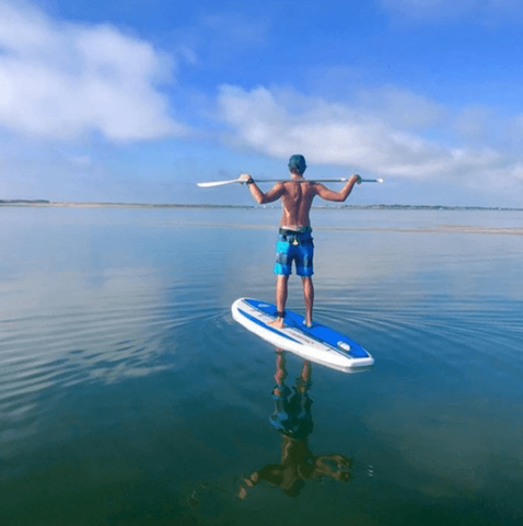 a man stand up paddle boarding