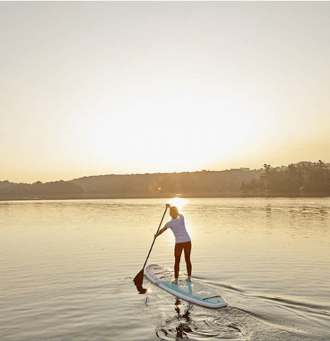 female paddle boarder on a lake