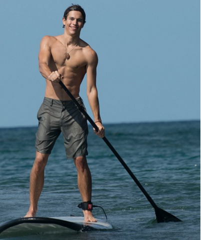 Stand Up Paddle Boarder Wearing a SUP Leash in Calm Water