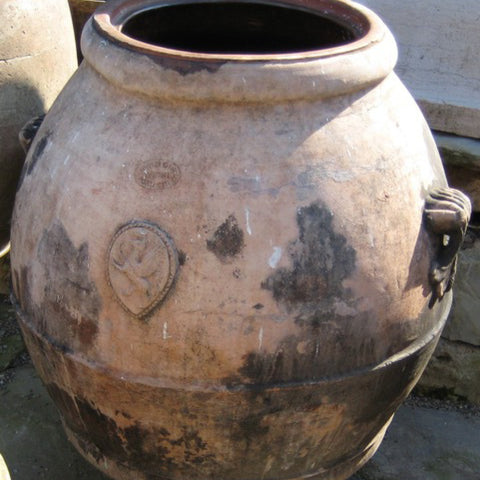 Tuscan Style Home Décor: A Guide The 5 Main Things to Know - Antique oil jars from Italy, like this one, are often decorated with a medallion or stemma showing a specific date, place, or family name, telling us a piece of the terracotta jar’s unique origin story.