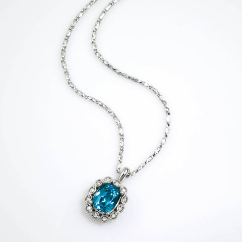 blue zircon pendant with diamonds and vintage style details, set in white gold