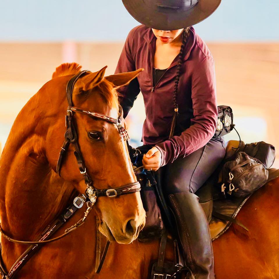Dawn Champion riding her brown horse, Lasiar