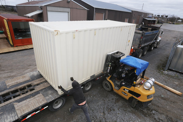 Loading a 20ft Seacan with a forklift truck.  Forklift services available